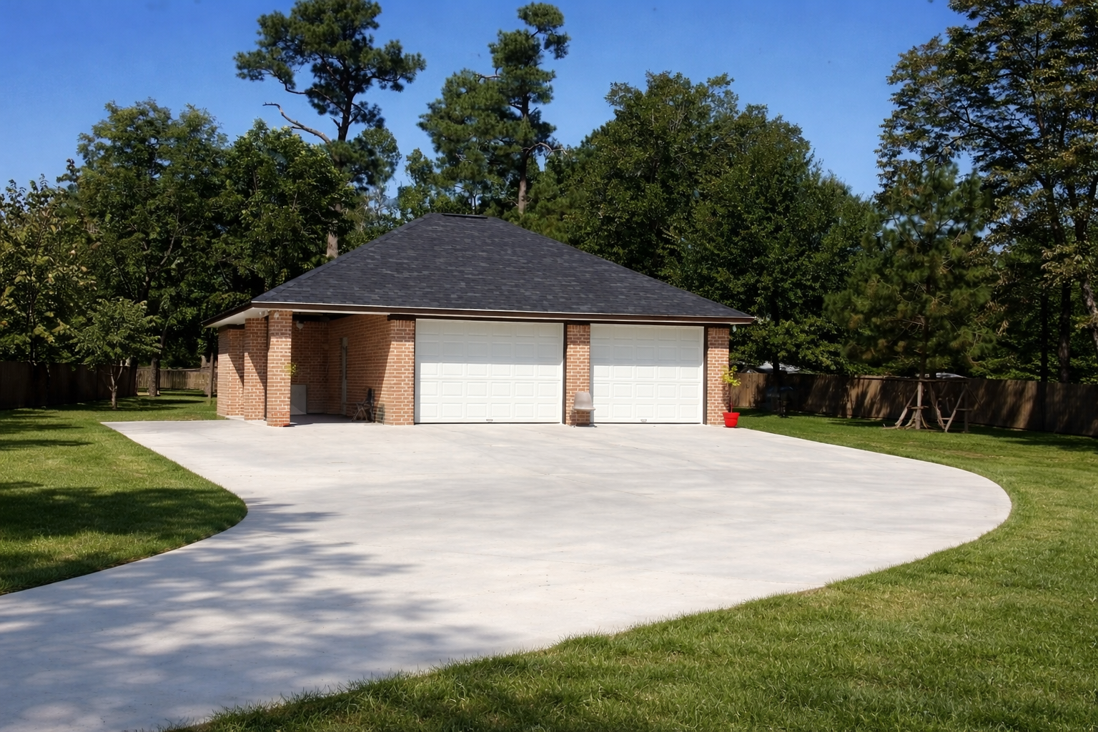 Brick garage addition with curved concrete driveway